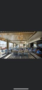 a large building with tables and chairs in it at HF - Mamaia Nord Building Resort in Mamaia Sat/Năvodari