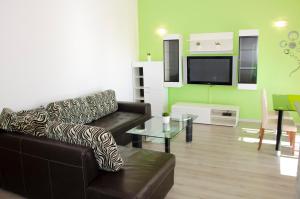 a living room with a couch and a table at Apartments Vodanović in Podgora