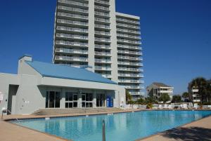 a large building with a swimming pool in front of a building at 1 Bedroom Condo with Amazing View in Pensacola Beach