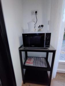 a microwave on a shelf in a room at La room in Joue-les-Tours