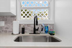 a kitchen sink with a faucet and a window at Available for Season! Siesta Shores #9 in Sarasota +37 photos