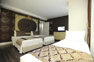Postel nebo postele na pokoji v ubytování Katelya Hotel