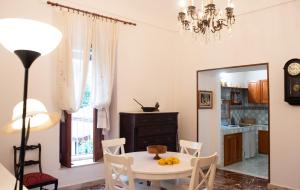 a dining room with a table and a mirror at La Cortese, cuore barocco in Noto