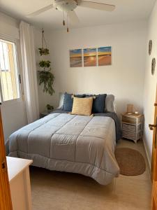a bedroom with a large bed with blue pillows at Bright apartment with private terrace and sea views in Bolnuevo +38 photos
