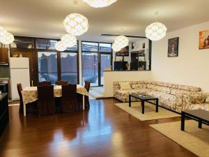 a living room with a couch and a table at AUM House in Bucharest