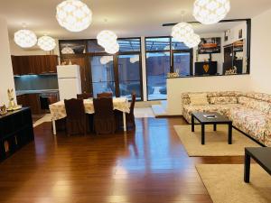 a living room with a couch and a table at AUM House in Bucharest +40 photos