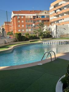 a large swimming pool in front of a building at Marina in Torrevieja