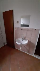 a bathroom with a sink and a mirror on the wall at Penzion Potočná in Žarnovica
