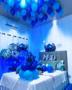a group of blue balloons hanging from a ceiling at Casa de Wen in Santa Rita