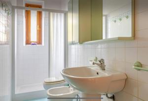 a bathroom with a sink and a toilet at La Loggia del Ciliegio in Montespertoli
