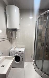 a bathroom with a washing machine and a sink at White Homes 16 - Master Quart in Podgorica +11 photos