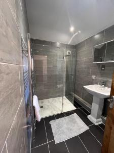 a bathroom with a shower and a sink at The Grenadine House in South Norwood +45 photos