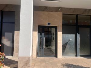 an entrance to a building with glass doors at White Homes 16 - Master Quart in Podgorica