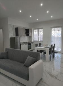 a living room with a couch and a table with chairs at Dodi's house in Pozzuoli +66 photos