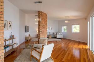 a living room with a brick pillar and a table at House on the Hillside with City Views Sleeps 12 in Howrah