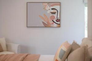 a picture of a woman on a wall in a living room at House on the Hillside with City Views Sleeps 12 in Howrah