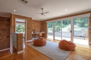 a living room with a brick wall at House on the Hillside with City Views Sleeps 12 in Howrah