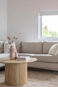 a living room with a couch and a coffee table at House on the Hillside with City Views Sleeps 12 in Howrah