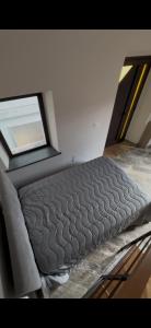a bed in a room with a window at La capannetta house in Castiglione di Sicilia +4 photos