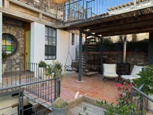 a patio with two chairs and a heater at CasaBlanca Hotel in Real de Catorce +138 photos
