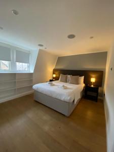 a bedroom with a white bed and a window at CS Exclusive Apartments of Princess Street West End in Edinburgh