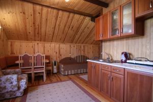 uma cozinha com paredes de madeira e uma sala de jantar com uma mesa em Blizzard em Slavske