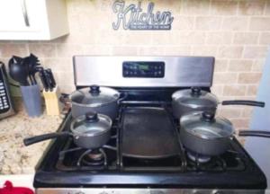 a stove with three pots on top of it at Charles Stays in Kansas City