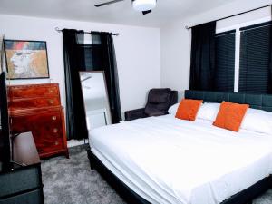 a bedroom with a bed and a chair and a dresser at Charles Stays in Kansas City +53 photos