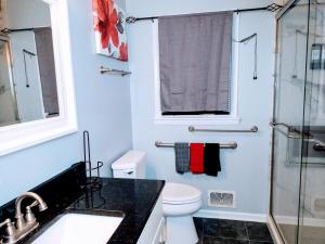 a bathroom with a toilet and a glass shower at Charles Stays in Kansas City +53 photos