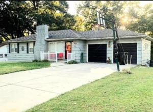 a small white house with a garage at Charles Stays in Kansas City
