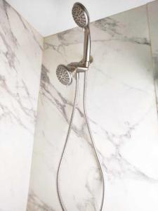 a shower with a shower head in a bathroom at Charles Stays in Kansas City