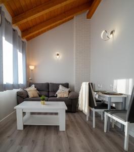 salon z kanapą i stołem w obiekcie Apartamentos Aranda w mieście Aranda de Duero