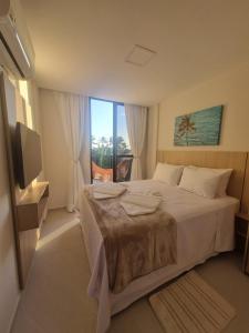 a bedroom with a large bed and a large window at Cais Eco Residência, Luxo, Requinte e Conforto em Muro Alto in Porto De Galinhas +122 photos