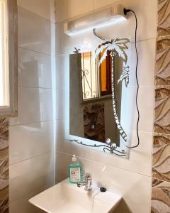 a bathroom with a sink and a mirror at Luma in Yaoundé