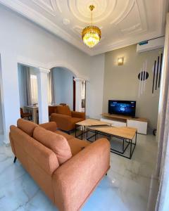 a living room with a couch and a table at Luma in Yaoundé