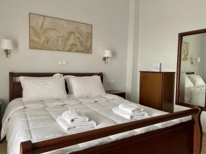 Posteľ alebo postele v izbe v ubytovaní Ξενώνας Ρόδον