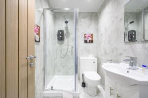 a bathroom with a shower and a toilet and a sink at -75ACR- Setup for your relaxed & amazing stay in Leeds