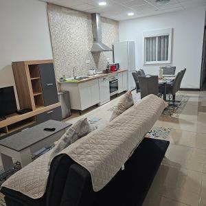 a living room with a couch and a kitchen at Apartamento Mar y sol in Alicante +3 photos