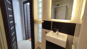 a bathroom with a sink and a mirror at Bright 2-BDRM central apartment in Tallinn +13 photos