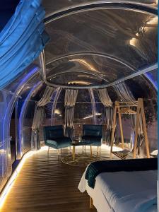 a room with a bed and chairs on a boat at Sial Skynest in Vlorë