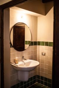 a bathroom with a sink and a mirror at Fattoria San Paolo Agriturismo in Montecastelli