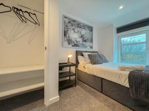 a bedroom with a bed and a window at Silver Birch - Dowlais in Merthyr Tydfil