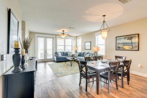 a dining room and living room with a table and chairs at Driftwood Galveston Resort Escape with Deck and View in Galveston