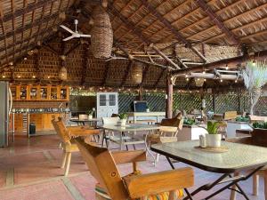 a restaurant with tables and chairs and a ceiling at Olas de Cerritos in El Pescadero