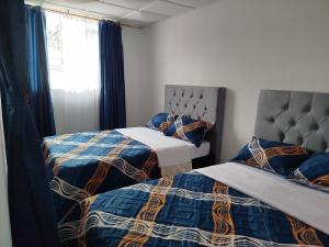 Postel nebo postele na pokoji v ubytování Serene Home