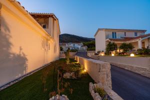 a courtyard of a house with lights on it at Villa Mirage with Private Heated Pool in Orebić