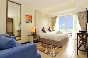 a bedroom with a bed and a large mirror at Belian Hotel in Tagbilaran City