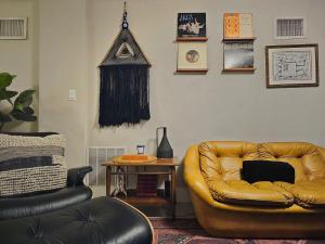 a living room with a leather couch and a table at -Disco Bungalow- One third mile to FTL Marine Center in Fort Lauderdale
