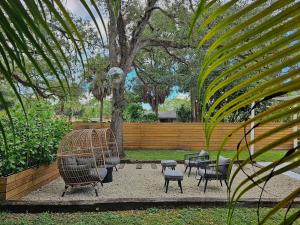 a group of chairs and tables in a park at -Disco Bungalow- One third mile to FTL Marine Center in Fort Lauderdale