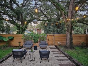 a patio with chairs and a table and a tree at -Disco Bungalow- One third mile to FTL Marine Center in Fort Lauderdale